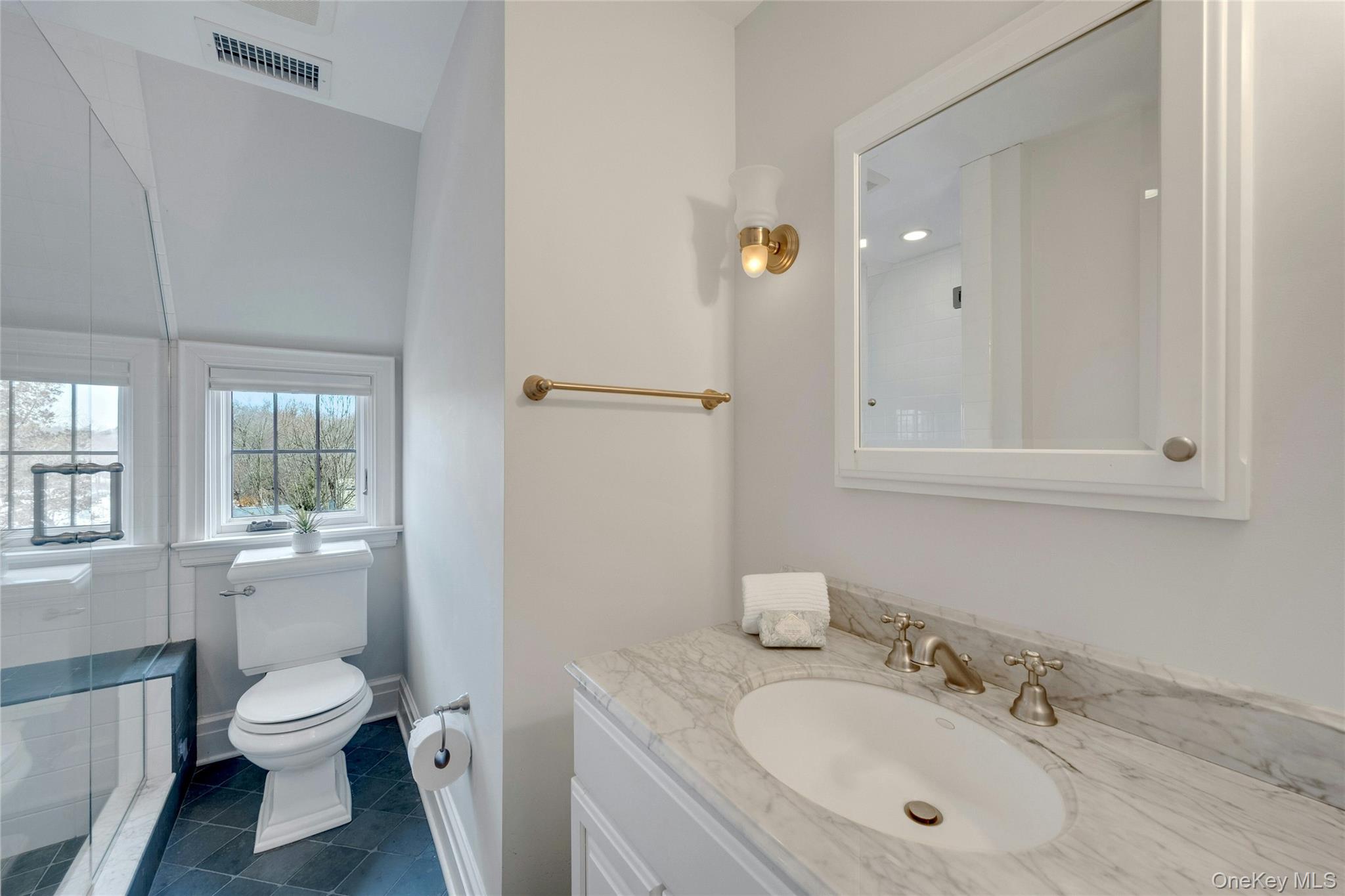 15 Carstensen Road Scarsdale, NY 10583 - Photo 24 of 35 a bathroom with a granite countertop toilet a sink and a mirror
