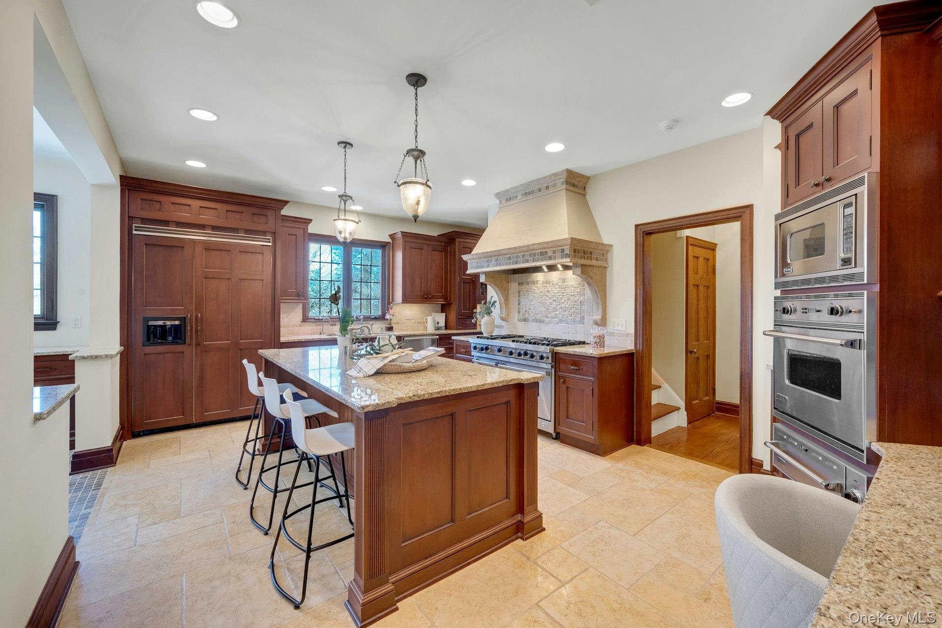 15 Carstensen Road Scarsdale, NY 10583 - Photo 7 of 35 a kitchen with stainless steel appliances granite countertop a stove a sink a refrigerator and a dining table