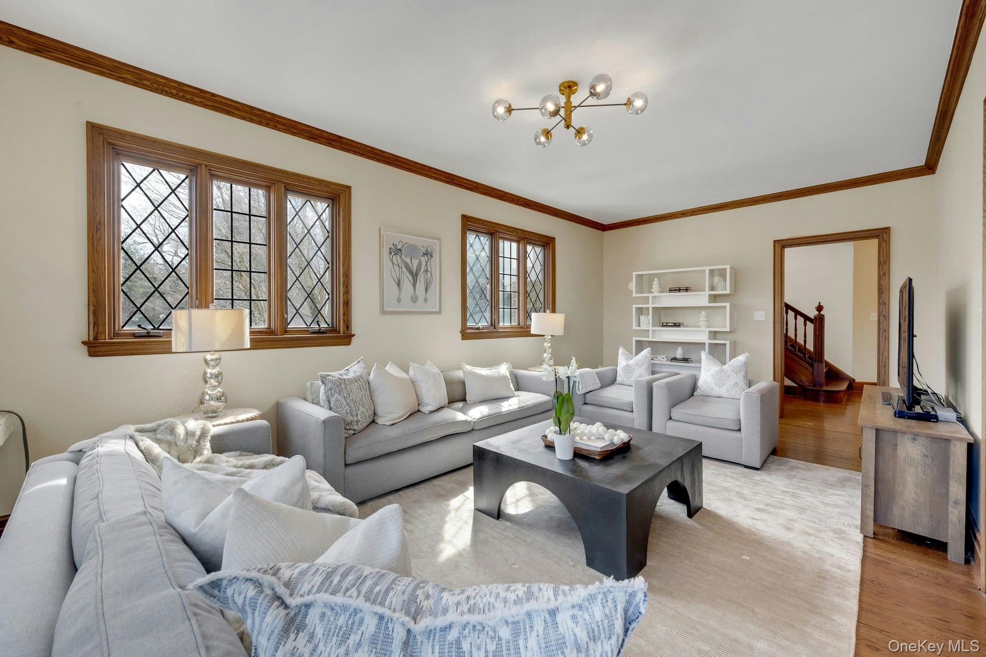 15 Carstensen Road Scarsdale, NY 10583 - Photo 10 of 35 a living room with furniture a flat screen tv and a window