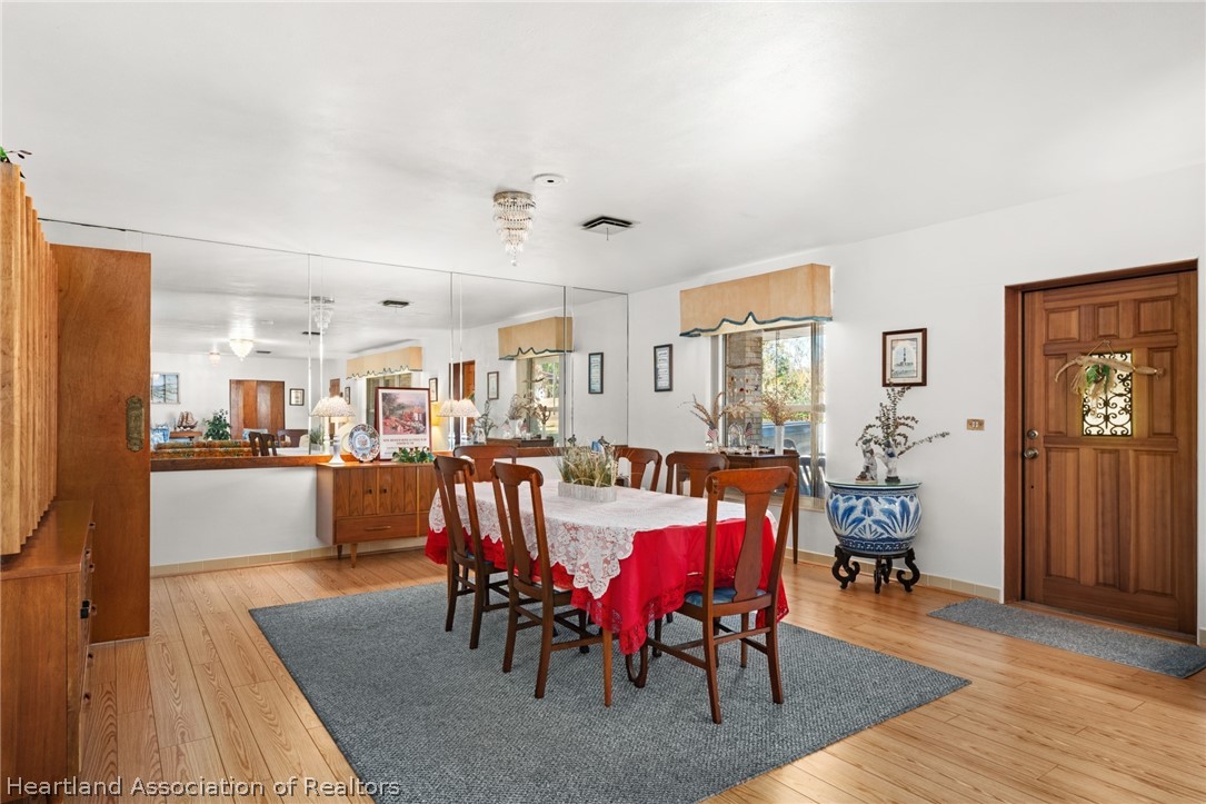 325 Sunset Road Frostproof, FL 33843 - Photo 11 of 48 a view of a a dining room with furniture and wooden floor