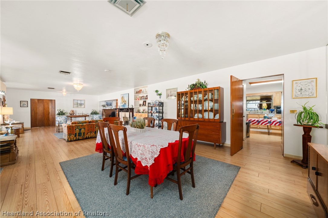 325 Sunset Road Frostproof, FL 33843 - Photo 12 of 48 a dining room with furniture and wooden floor