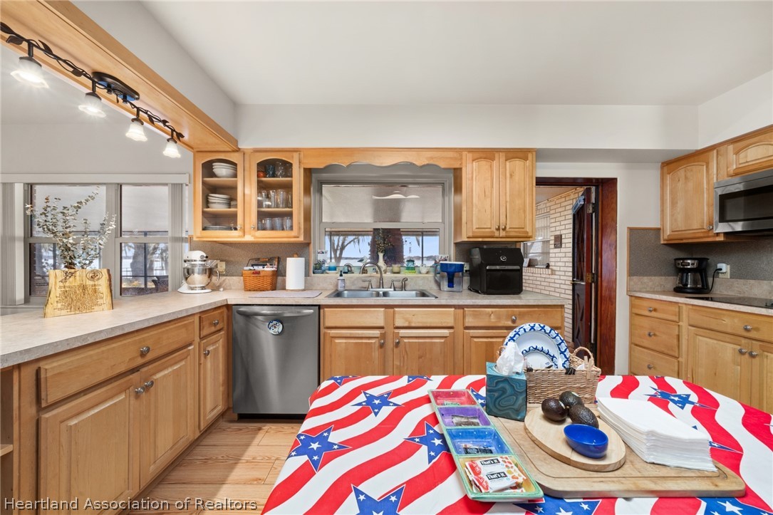 325 Sunset Road Frostproof, FL 33843 - Photo 15 of 48 a kitchen that has a lot of cabinets a sink and appliances