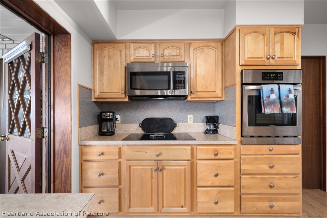 325 Sunset Road Frostproof, FL 33843 - Photo 16 of 48 a kitchen with stainless steel appliances granite countertop a stove a sink and a microwave