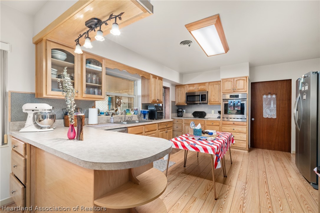 325 Sunset Road Frostproof, FL 33843 - Photo 17 of 48 a kitchen with sink refrigerator dining table and chairs