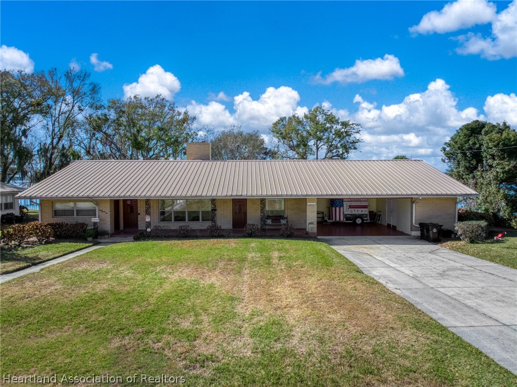 325 Sunset Road Frostproof, FL 33843 - Photo 2 of 48 a view of a house with a yard and sitting area