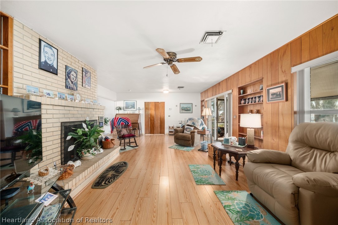 325 Sunset Road Frostproof, FL 33843 - Photo 22 of 48 a living room with furniture or fireplace and a chandelier