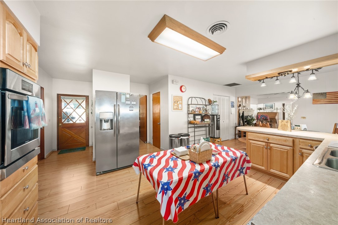 325 Sunset Road Frostproof, FL 33843 - Photo 23 of 48 a kitchen with stainless steel appliances granite countertop a sink and a refrigerator