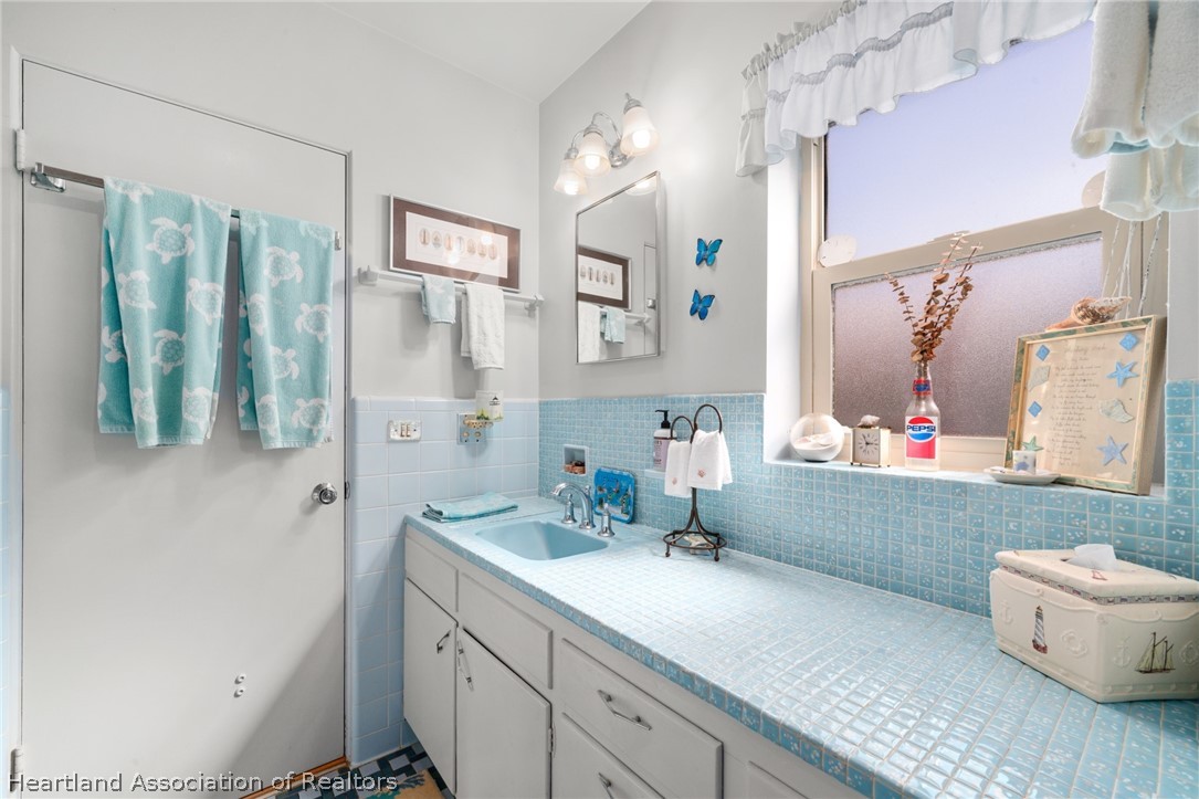 325 Sunset Road Frostproof, FL 33843 - Photo 37 of 48 a bathroom with a double vanity sink mirror and toilet