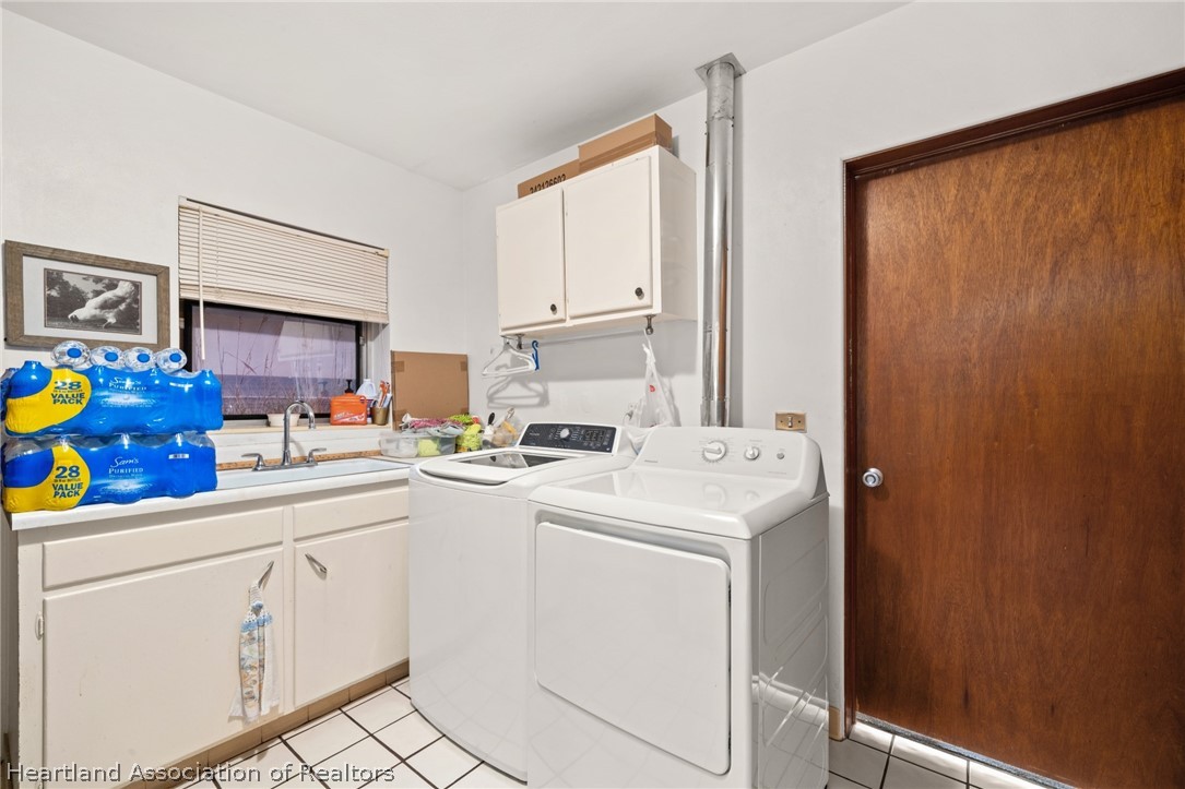 325 Sunset Road Frostproof, FL 33843 - Photo 40 of 48 a view of washer and dryer with white cabinets