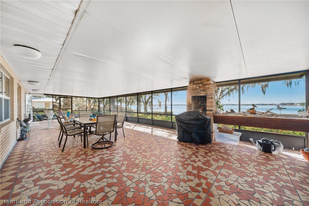325 Sunset Road Frostproof, FL 33843 - Photo 41 of 48 a dining room with furniture and a floor to ceiling window