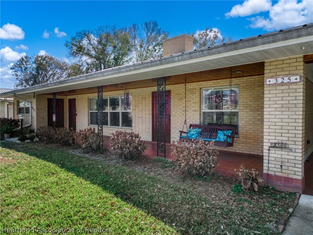 325 Sunset Road Frostproof, FL 33843 - Photo 43 of 48 a front view of a house with garden