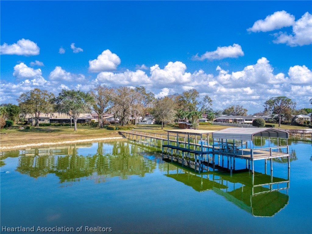 325 Sunset Road Frostproof, FL 33843 - Photo 45 of 48 a view of a swimming pool with an outdoor seating and a yard