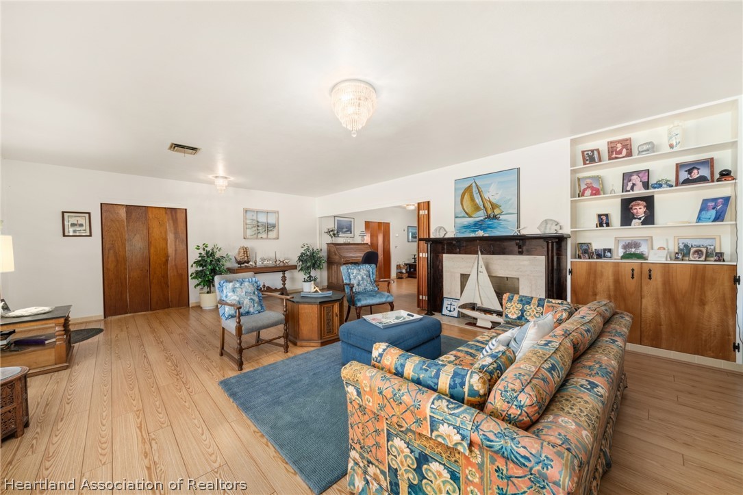 325 Sunset Road Frostproof, FL 33843 - Photo 8 of 48 a living room with furniture and a wooden floor