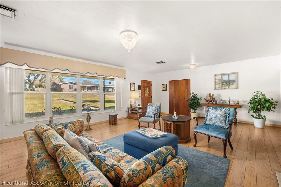 325 Sunset Road Frostproof, FL 33843 - Photo 9 of 48 a living room with furniture and a large window