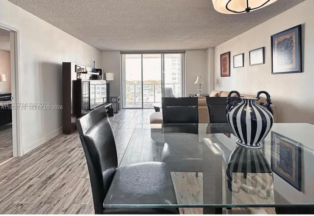 a view of a livingroom with furniture window and wooden floor