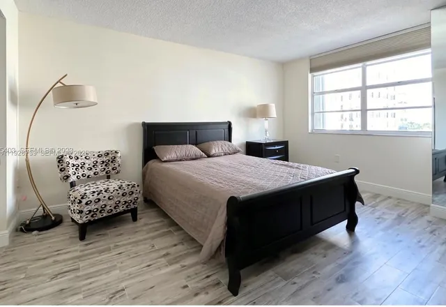 a bedroom with a bed window and a table