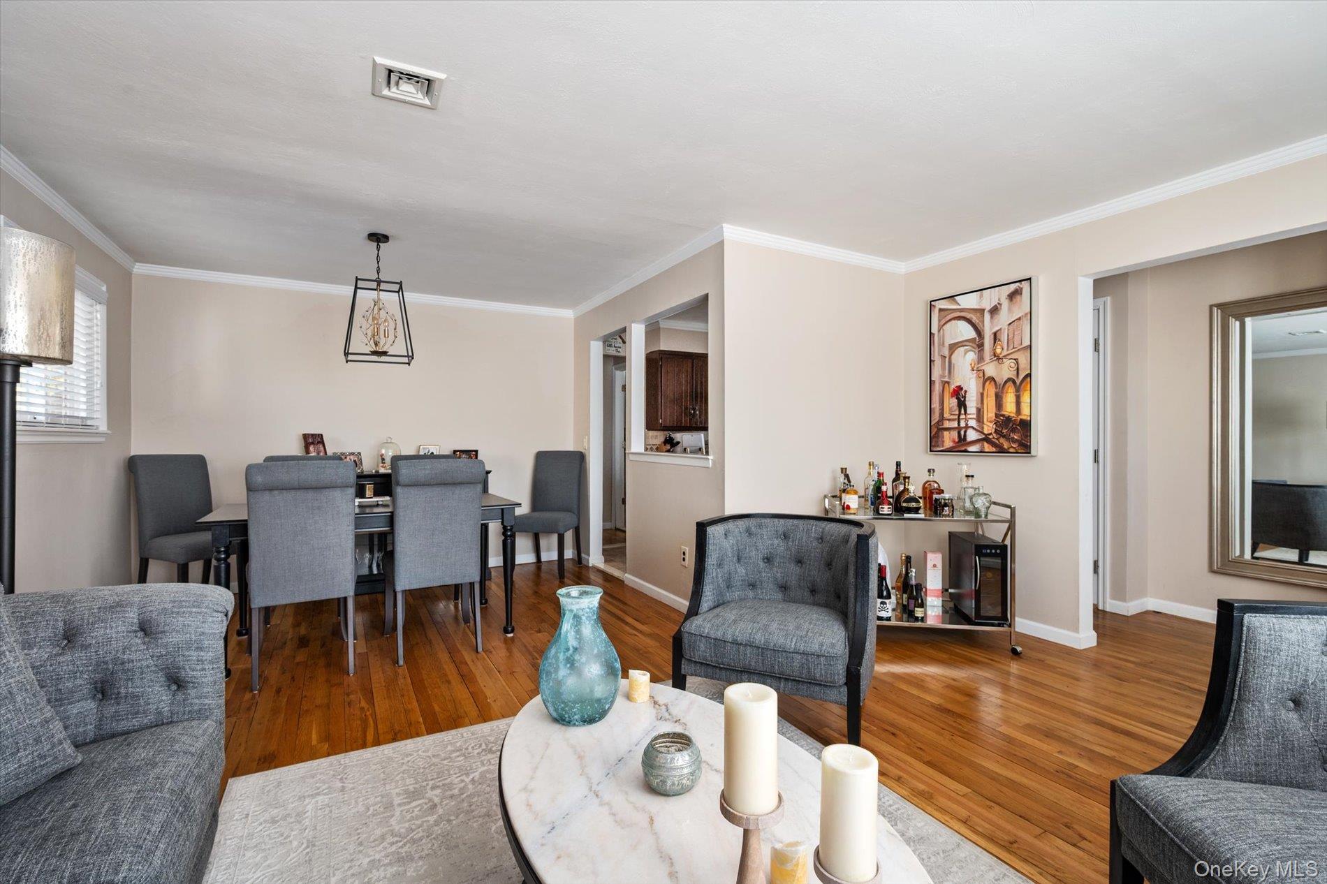 249 Hampton Road West Babylon, NY 11704 - Photo 7 of 22 a living room with furniture kitchen view and a wooden floor