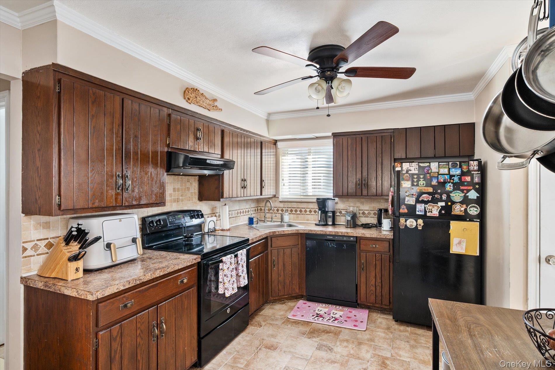 249 Hampton Road West Babylon, NY 11704 - Photo 9 of 22 a kitchen with a sink a stove and cabinets
