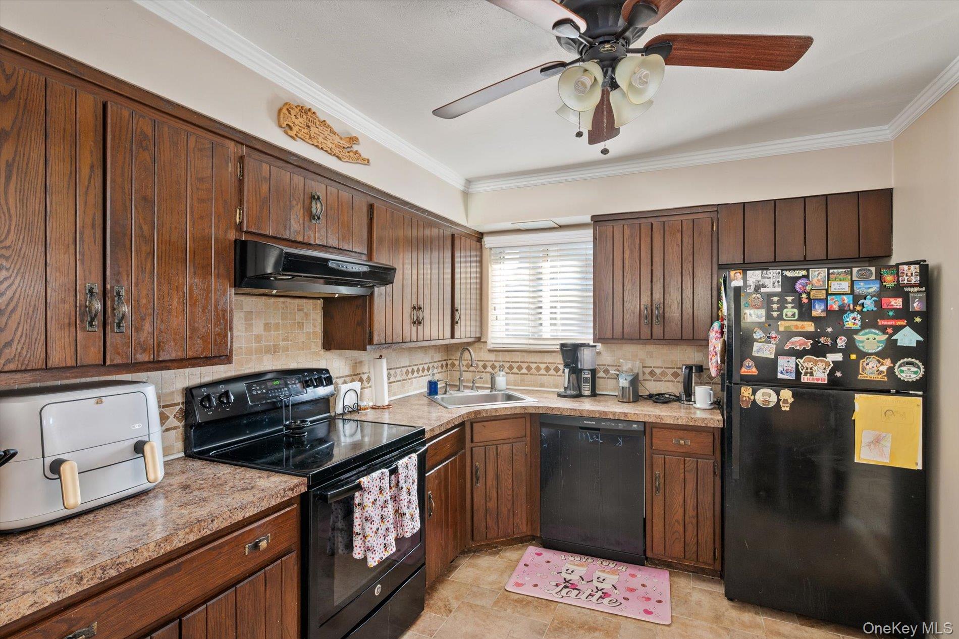 249 Hampton Road West Babylon, NY 11704 - Photo 10 of 22 a kitchen with a sink a stove cabinets and chandelier