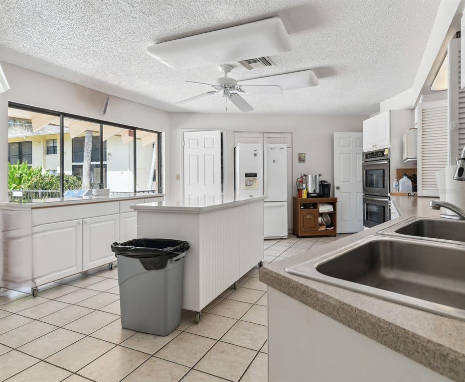 12300 Vonn Road, Unit 3102 Largo, FL 33774 - Photo 19 of 22 a kitchen that has a sink and a stove with wooden floor