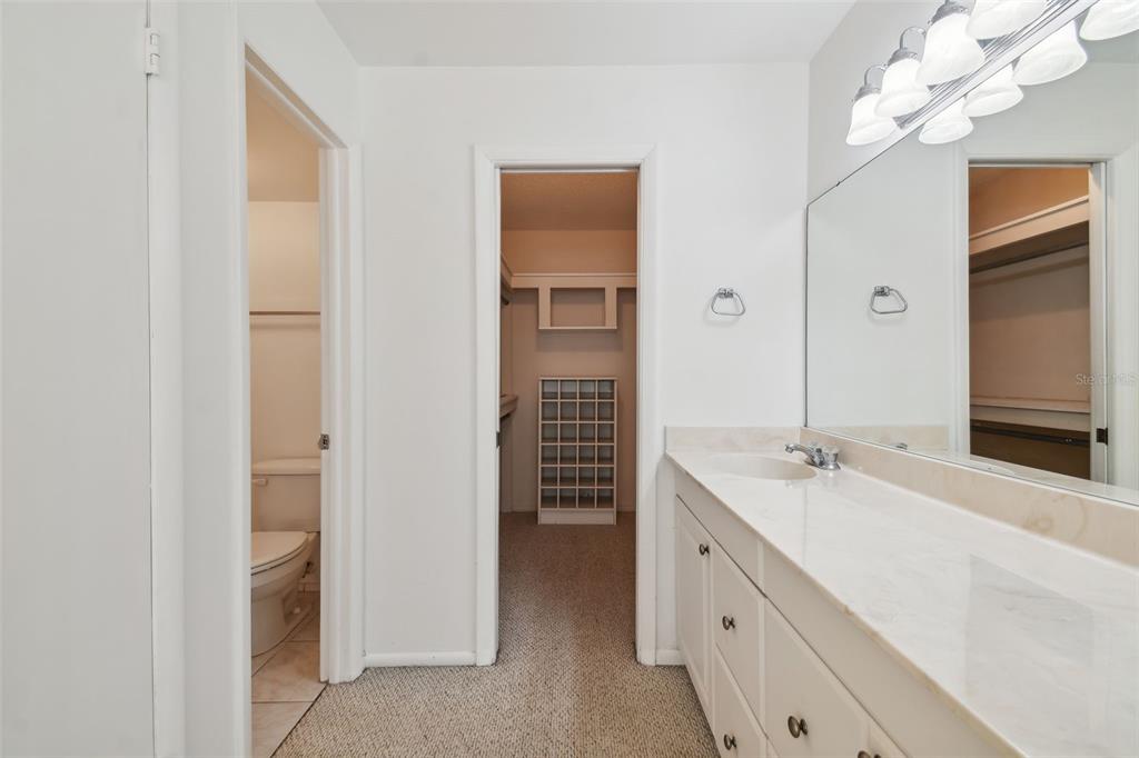 12300 Vonn Road, Unit 3102 Largo, FL 33774 - Photo 5 of 22 a spacious bathroom with a double vanity sink and a mirror