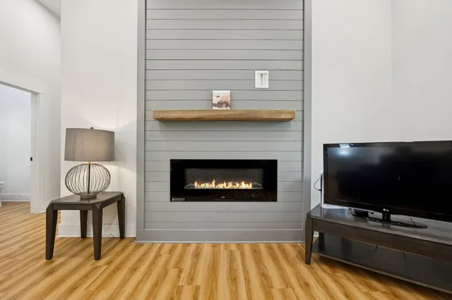 a living room with a flat screen tv and a fireplace