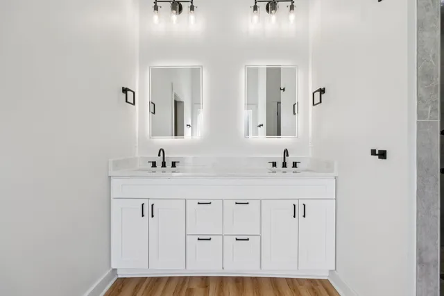 a bathroom with sinks mirror and vanity