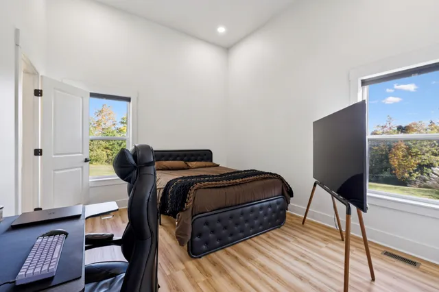 a bedroom with a bed and a window