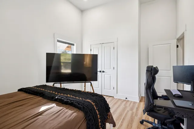 a bedroom with a bed and a flat screen tv