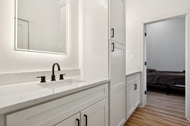 a en suite bathroom with a sink and a mirror