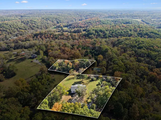 an aerial view of a houses with a yard