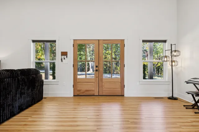 a view of a living room with furniture and windows