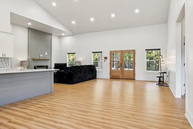 a large room with wooden floor and windows