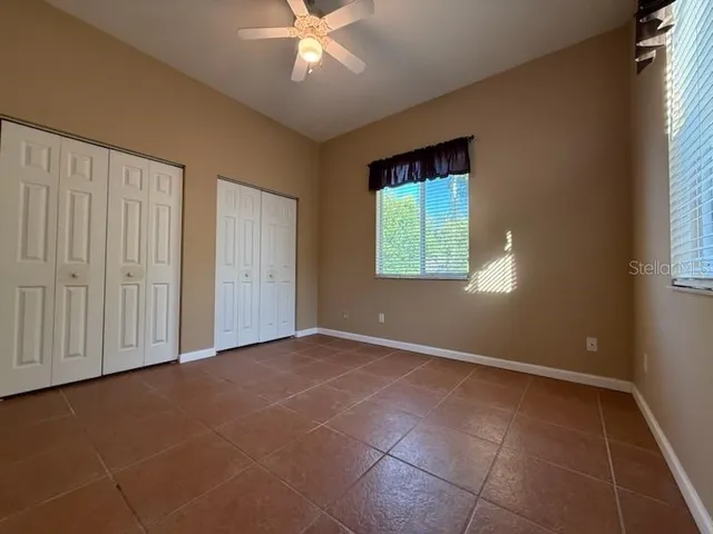 an empty room with windows and closet