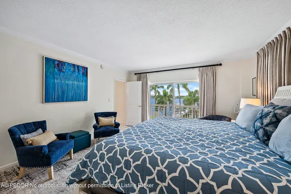 a bedroom with a bed a couch and dresser