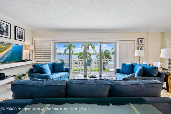 a living room with furniture and a floor to ceiling window