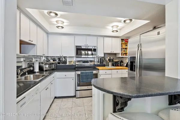 a kitchen with stainless steel appliances granite countertop sink and cabinets
