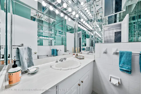 a bathroom with a sink mirror toilet and bathtub