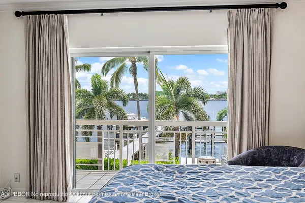a bedroom with a bed and glass window
