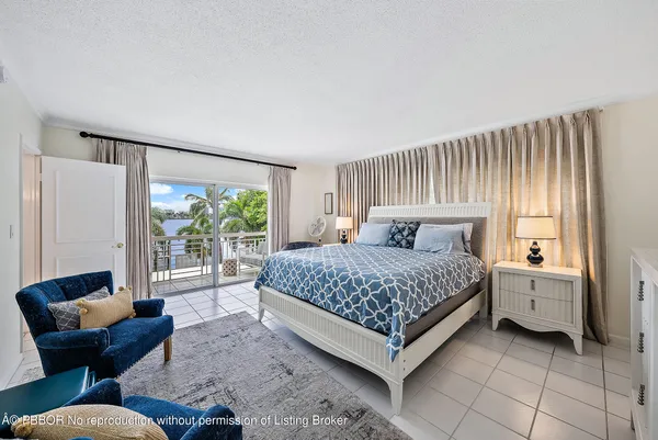 a bedroom with a bed and glass window