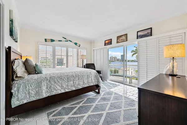 a bedroom with a bed and a lamp on table