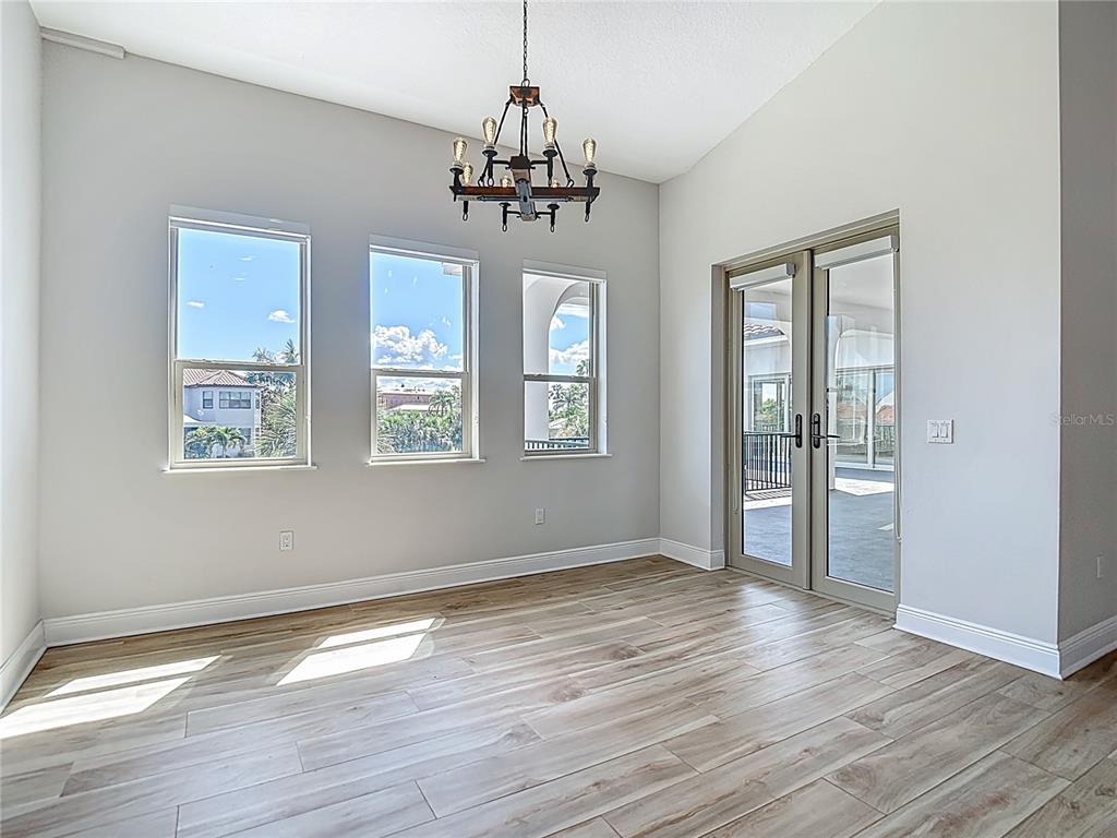 1329 Jumana Loop Apollo Beach, FL 33572 - Photo 11 of 40 a view of an empty room with wooden floor and a window