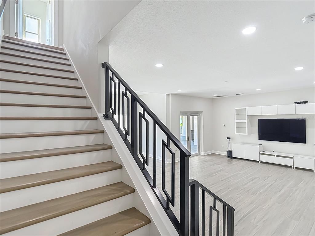 1329 Jumana Loop Apollo Beach, FL 33572 - Photo 38 of 40 a view of an empty room with wooden floor and stairs