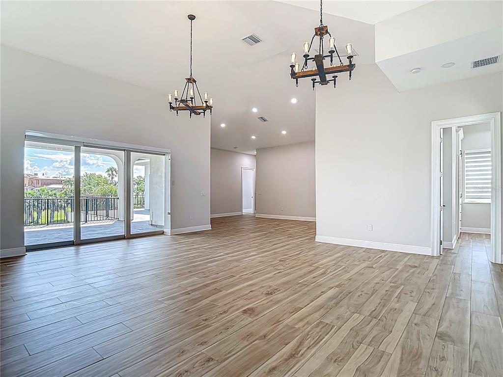 1329 Jumana Loop Apollo Beach, FL 33572 - Photo 4 of 40 a view of a room with wooden floor chandelier and windows