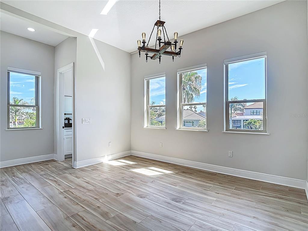 1329 Jumana Loop Apollo Beach, FL 33572 - Photo 9 of 40 a view of an empty room with wooden floor and a window
