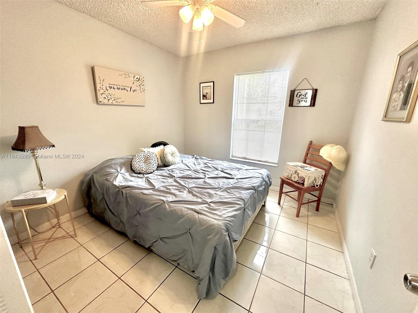14200 Kendale Lakes Drive Miami, FL 33183 - Photo 12 of 21 a bedroom with a bed and a chandelier
