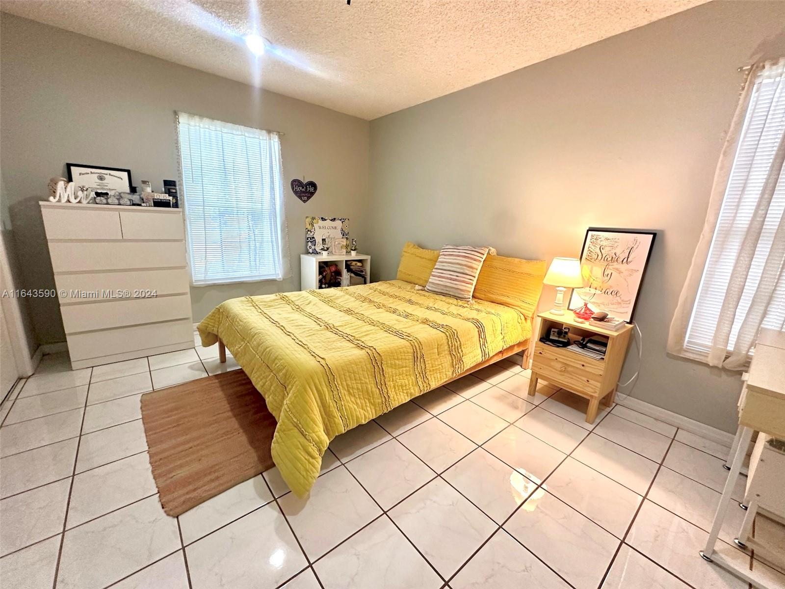 14200 Kendale Lakes Drive Miami, FL 33183 - Photo 13 of 21 a bedroom with a bed and a walk in closet