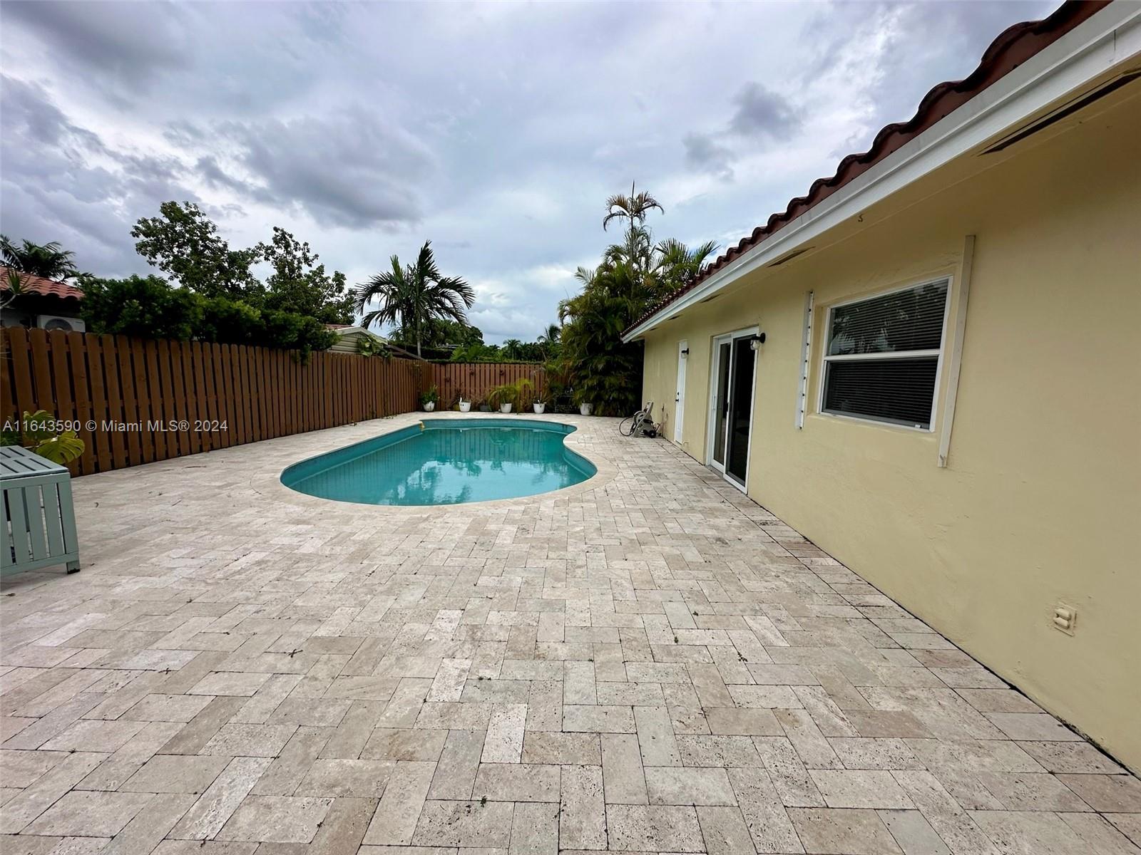 14200 Kendale Lakes Drive Miami, FL 33183 - Photo 19 of 21 a backyard of a house with fountain table and chairs