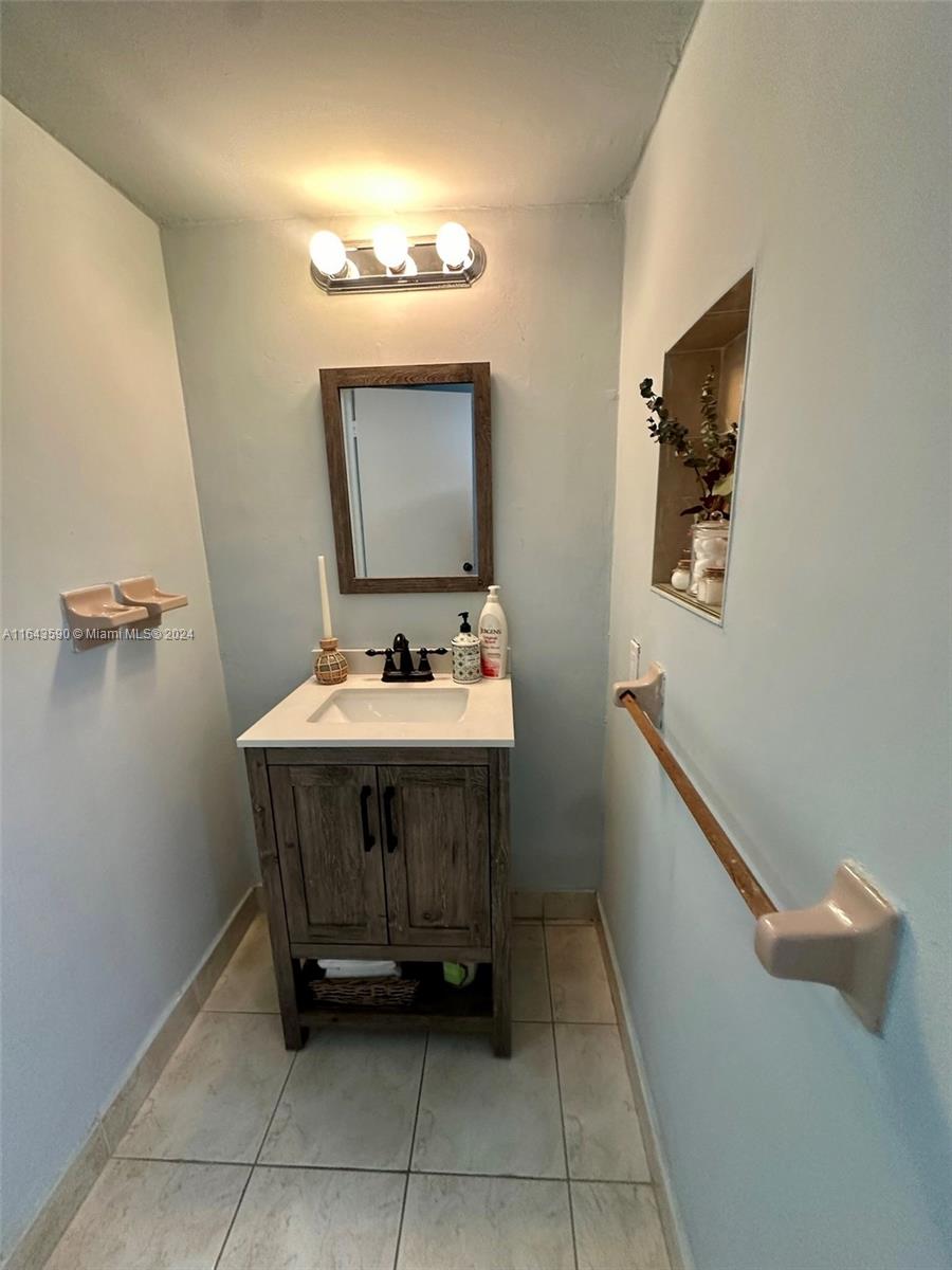 14200 Kendale Lakes Drive Miami, FL 33183 - Photo 7 of 21 a bathroom with a sink a mirror and vanity