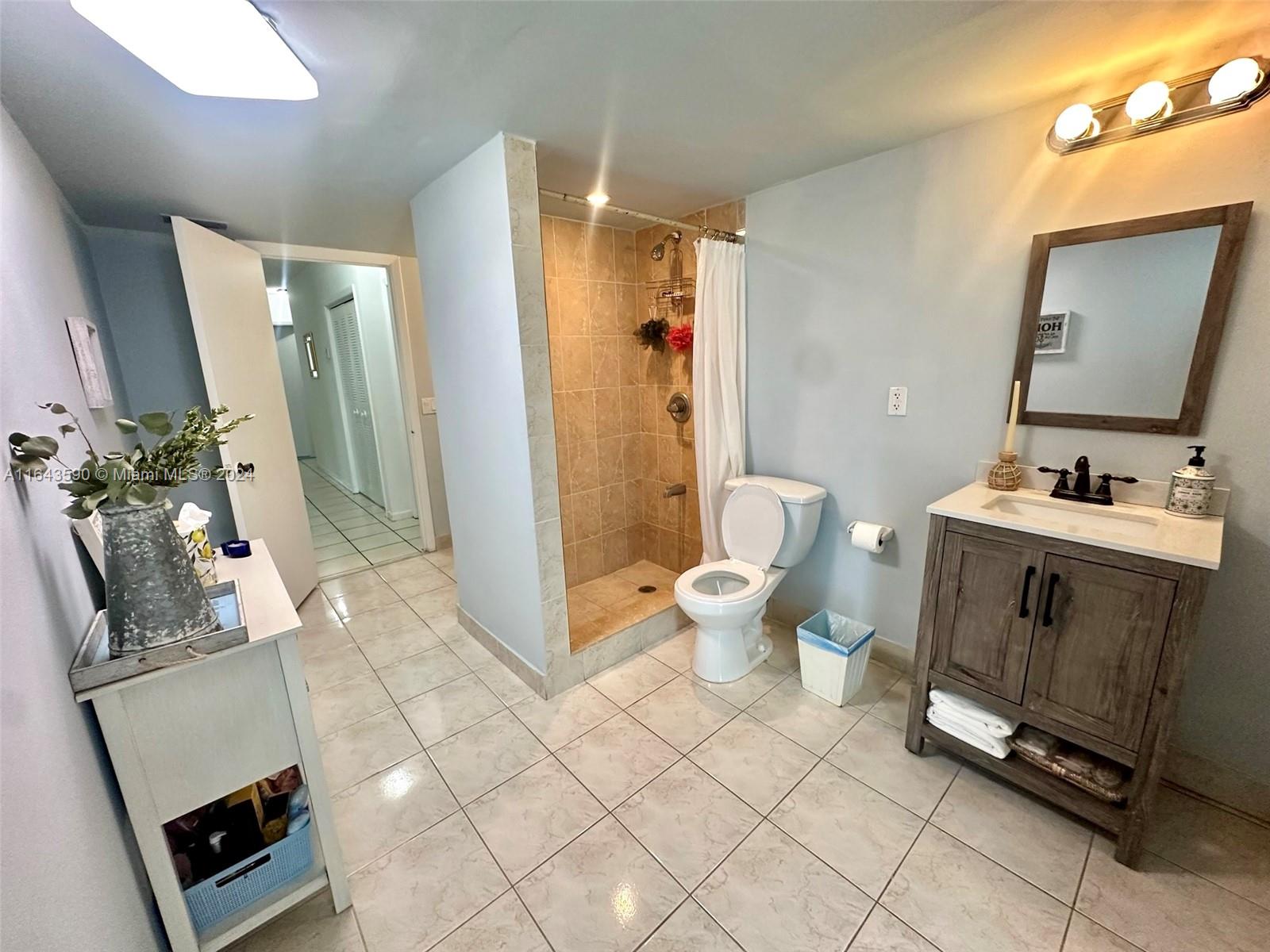 14200 Kendale Lakes Drive Miami, FL 33183 - Photo 8 of 21 a spacious bathroom with a toilet sink and mirror